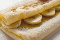 Crpes with bananas and syrup — Stock Photo