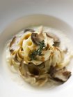 Ribbon pasta with ceps and sauce — Stock Photo