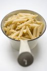 Penne pasta in strainer — Stock Photo