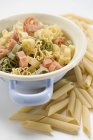Coloured pasta in strainer — Stock Photo