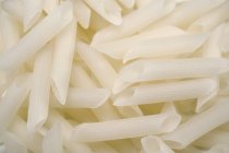 Dried white Penne pasta — Stock Photo