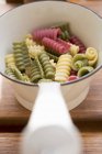 Closeup view of colored Riccioli pasta in strainer — Stock Photo
