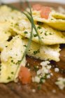 Ravioli pasta with diced tomatoes — Stock Photo