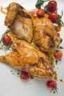 Roasted chicken with cherry tomatoes — Stock Photo