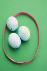 Eggs surrounded by ribbon — Stock Photo