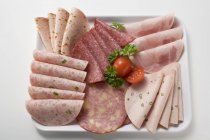 Cold cuts platter with cherry tomatoes — Stock Photo