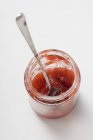 Jar with remains of strawberry jam — Stock Photo