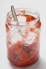 Jar with remains of strawberry jam — Stock Photo