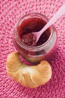 Raspberry jam and croissant — Stock Photo