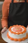 Woman holding Halloween cake — Stock Photo