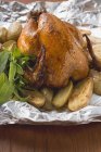 Roasted chicken with baked potatoes — Stock Photo