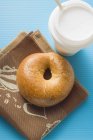 Plain baked Bagel and cup of coffee — Stock Photo