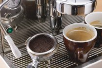 Cups of espresso on coffee machine — Stock Photo
