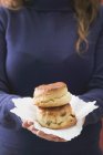 Woman holding two scones — Stock Photo