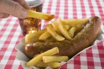 Currywurst sausage with fried potato chips — Stock Photo