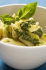 Rigatoni pasta with pesto and basil — Stock Photo
