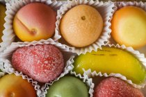 Closeup view of marzipan fruits in paper — Stock Photo