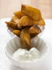 Fried country potatoes with yoghurt dip — Stock Photo