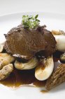 Roasted beef with morels and garlic — Stock Photo
