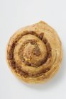Closeup top view of Danish pastry snail with nut filling — Stock Photo