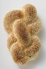 Top view of a sesame plait on white surface — Stock Photo
