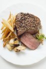 Beef fillet with fried potato chips — Stock Photo