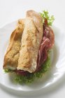 Sandwich with raw ham and lettuce — Stock Photo