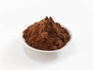 Cocoa powder in white bowl — Stock Photo