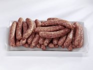 Fresh sausages on plate — Stock Photo