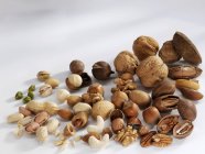 Assorted shelled and unshelled nuts — Stock Photo