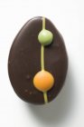 Nahaufnahme von dekorierten Schokoladen-Ei-Form-Kuchen auf weißer Oberfläche — Stockfoto