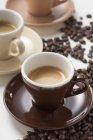 Cups of espresso and coffee beans — Stock Photo