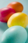 Coloured eggs on green — Stock Photo