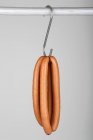 Pairs of frankfurters on a hook — Stock Photo