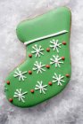 Christmas biscuit in shape of green boot — Stock Photo