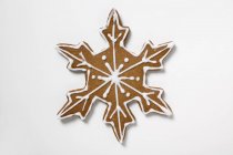 Gingerbread snowflake on white — Stock Photo