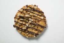 Biscuit with nuts and chocolate drizzle — Stock Photo