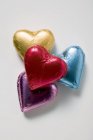 Chocolate hearts in coloured foil — Stock Photo
