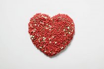 Chocolate heart with sprinkles — Stock Photo