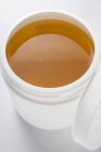 Honey in plastic container — Stock Photo