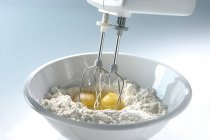 Mixing flour and eggs — Stock Photo