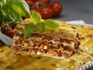 Portion of lasagne with basil — Stock Photo