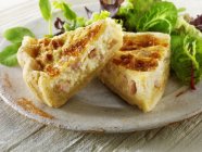 Two pieces of Quiche Lorraine with salad leaves — Stock Photo