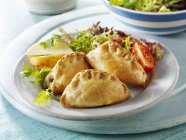 Closeup view of pasties with salad on plate — Stock Photo