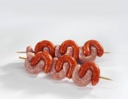 Speared skewered sausages — Stock Photo