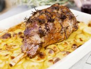 Leg of lamb on potato gratin — Stock Photo