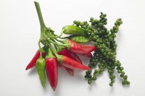 Banches of Chillies and green peppercorns — Stock Photo