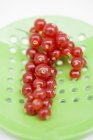 Redcurrants on slotted spoon — Stock Photo