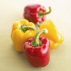 Red and two yellow peppers — Stock Photo