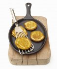 Small corn pancakes in frying pan — Stock Photo